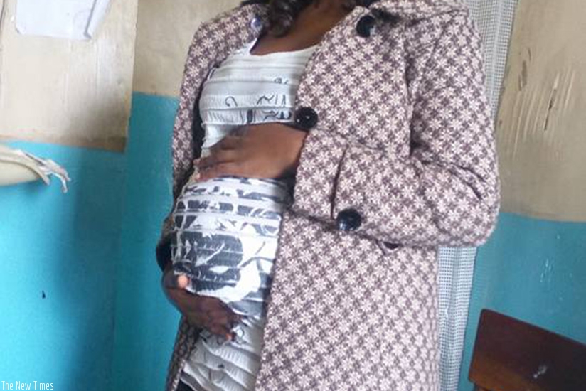 A woman shows off her baby bump. (Lydia Atieno)