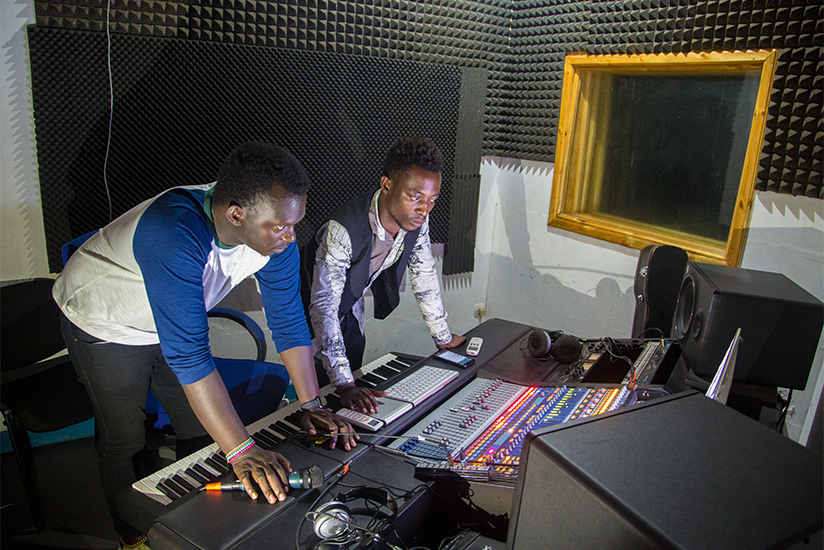 Beauty for Ashes' front man, Olivier Kavutse (left) in the studio with music producer Marc Kibamba. / Faustin Niyigena