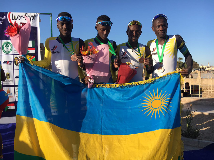 L-R: Valens Ndayisenga, Joseph Areruya, Samuel Mugisha and Jean Bosco Nsengimana pose with the national flag after winning the bronze medal in Team Time Trial on Tuesday. / Courtesy