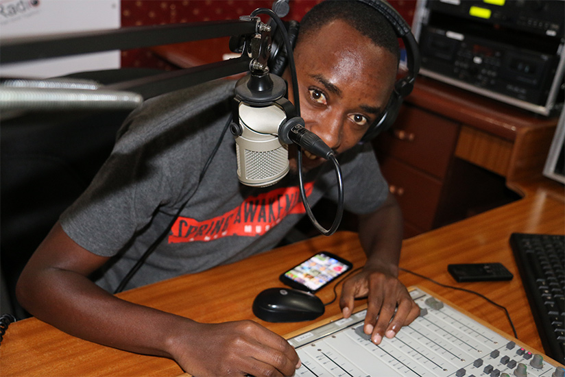 A radio presenter in Kigali during a show. / Timothy Kisambira