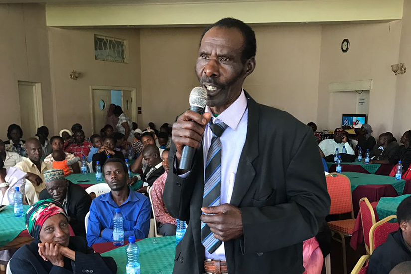 One of the affected Rwandans speaks at the meeting in Kenya. / Courtesy