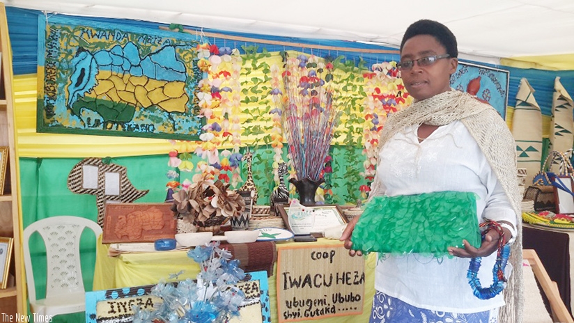 Ujeneza holding a bag and necklace that she made. (File photos)