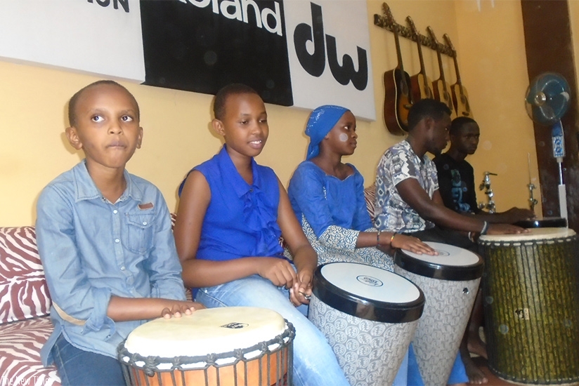 CLOCKWISE: Some of the children during a drumming session at the school last Sunday; Jaymo Mutinda, the drum instructor and director takes the children through a drum class; The ch....