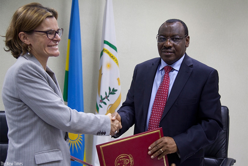 Beaufils (L) and Gatete exchange the MoU after the signing yesterday. Sam Ngendahimana.