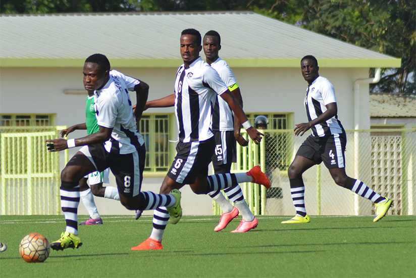 APR's attacking midfielder Djihad Bizimana controls the ball as Mukunzi (#6), Usengimana (#15) and Rugwiro (#4) look on during a past game. / Sam Ngendahimana