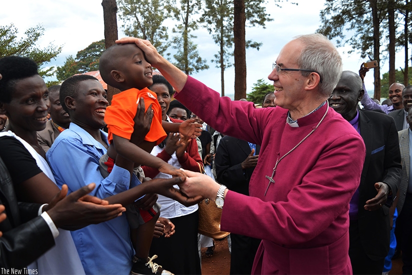 The Archibishop of Canterbury, The Most Rev. Justin Welby, blesses a child as the faithful welcome him to Gahini Diocese in Kayonza District on Saturday. (Photos by Sam Ngendahimana)