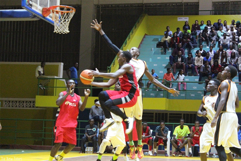 REG shooting guard Benjamin Mukengerwa tries to drop a point as APR players try to block him. He scored the game's high 17 points. (Geoffrey Asiimwe)