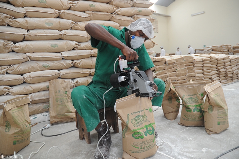 A staffer packs cassava flower at Kinazi Cassava Plant in Ruhango District. File.