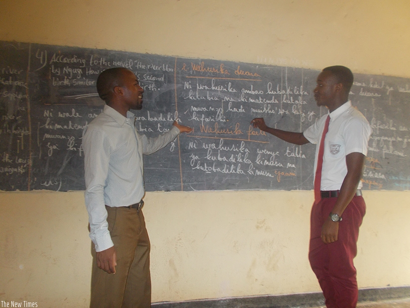 A teacher and his student hold a conversation in Swahili during a lesson. Most schools are grappling with the challenge of insufficient instructional materials. / Elias Hakizimana.