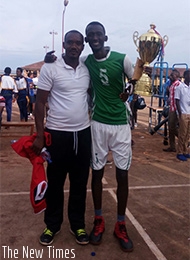 Muhirwa poses with the trophy and his coach Fidele Nyirimana after winning the Kayumba memory title Peter Kamasa 