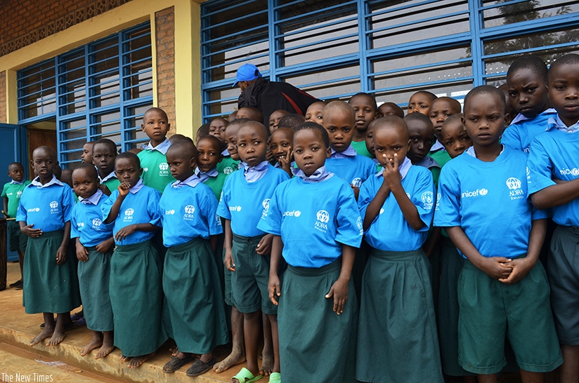 Burundian refugee children pose in front of their newly built classrooms near Mahama camp. Sam Ngendahimana.