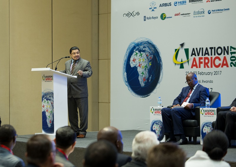 Abdullah M. Al-Sayed, the Founder and Chairman, Nexus, one of the sponsors of the event, gives his opening remarks as Infrastructure minister James Musoni (background) looks on. T.Kisambira