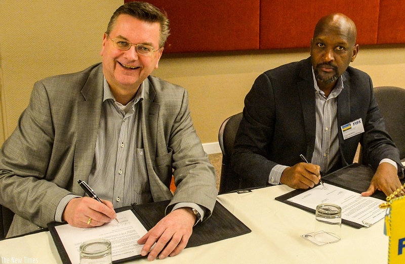 Nzamwita and his German counterpart ink the deal in Johannesburg on Wednesday. Courtesy.