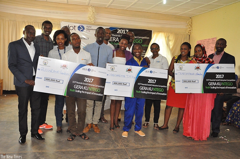 Winners in Kicukiro display dummy cheques on Thursday. Courtesy.