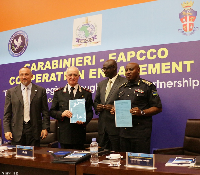 Lt Gen Tullio Del Sette and IGP  Emmanuel K. Gasana display copies of the signed MoU as Minister Johnston  Busingye and Italy's ambassador to Rwanda, Domenico Fornara look on. Courtesy.