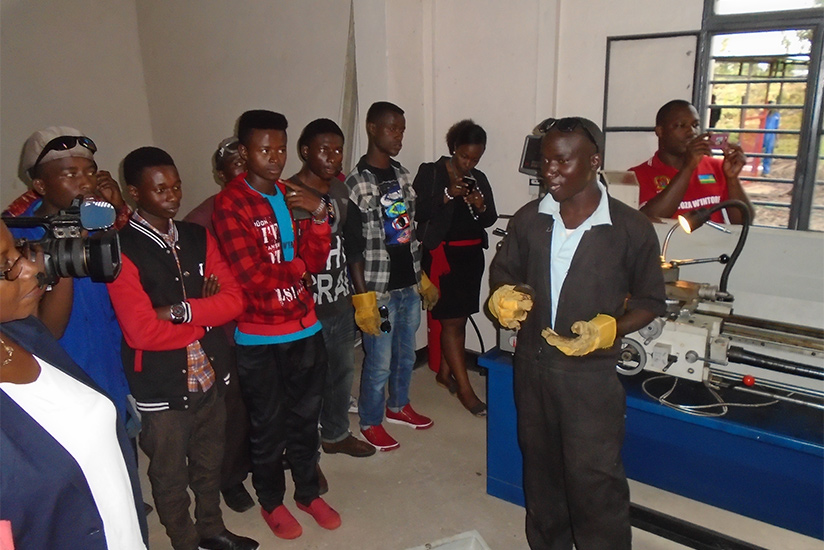 One of the students explains how the lathe machine works. (Photos by Steven Muvunyi)
