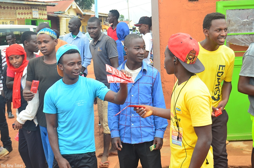 Young people receive condoms during an awareness campaign. File.