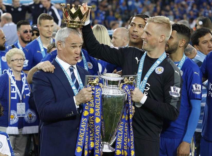 Leicester City manager Claudio Ranieri has the crown of the Premier League trophy placed on his head by goalkeeper Kasper Schmeichel as they celebrated becoming the English Premier....