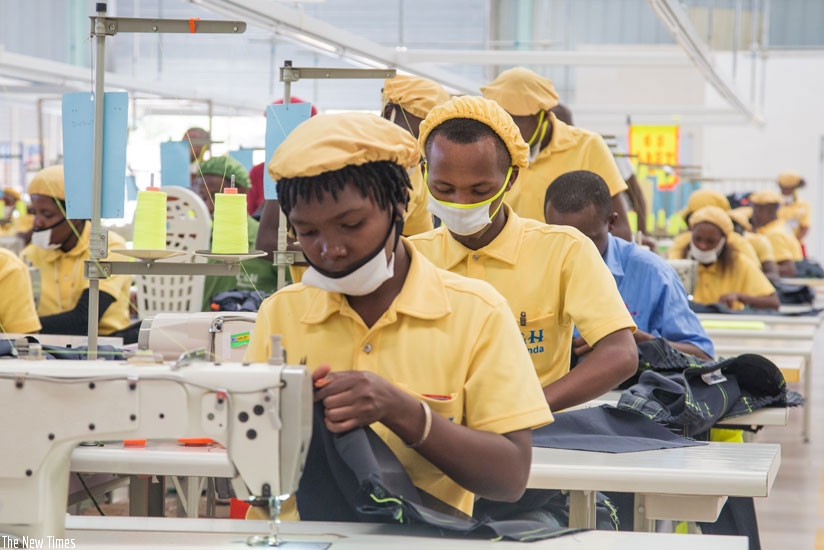 Women sew clothes at a local garments factory. (File photo)