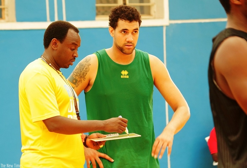 Head coach Moise Mutokambali  talkign to Bradley Cameroon during training at Amahoro Indoor Stadium on Friday. Courtesy.