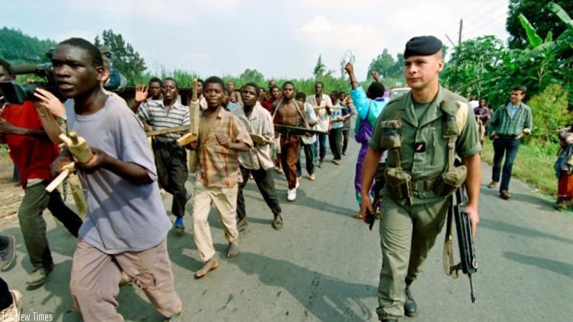 A French officer walks alongside training Interahamwe militia