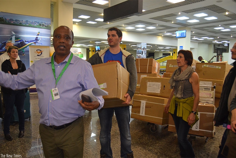 Ntavuka guides the medics at the Kigali International Airport on their arrival with medical equipment on Saturday. J. Mbonyinshuti.