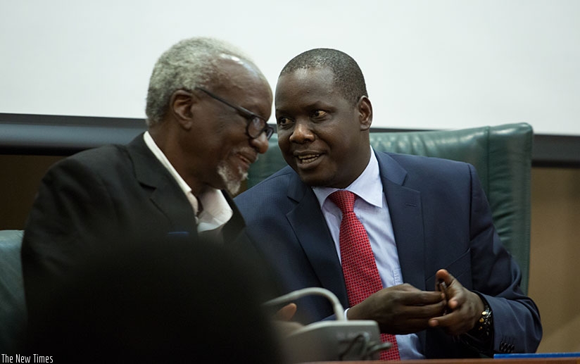 Kirunda Kivejinja, the Ugandan third deputy prime minister and minister for EAC Affairs (L), chats with Kidega during the news briefing in Kigali yesterday. Timothy Kisambira.
