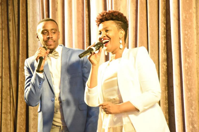 Billy Irakoze is joined on stage by Pastor Apotre Mignone. / Donata Kiiza