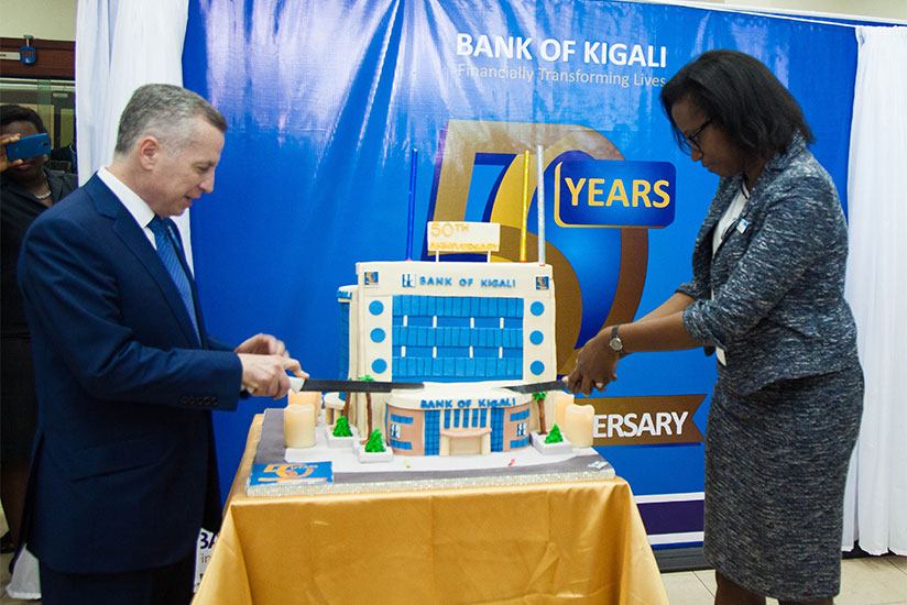 BK Chairman Marc Holtzman (L) and chief executive Dr Diane Karusisi cut cake during the bank's 50th anniversary celebrations at the bank's headquarters in Kigali earlier this year. / File