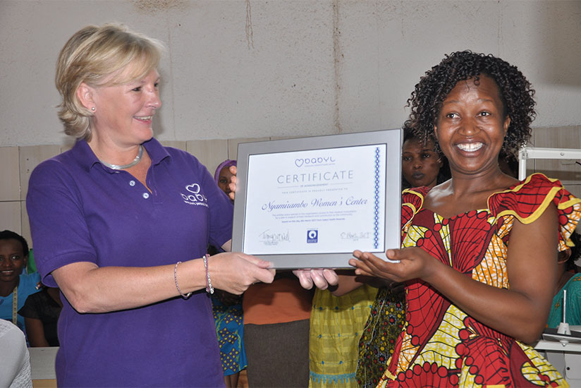 McNeil gives a certificate of the donation to Umugeni. / Steven Muvunyi