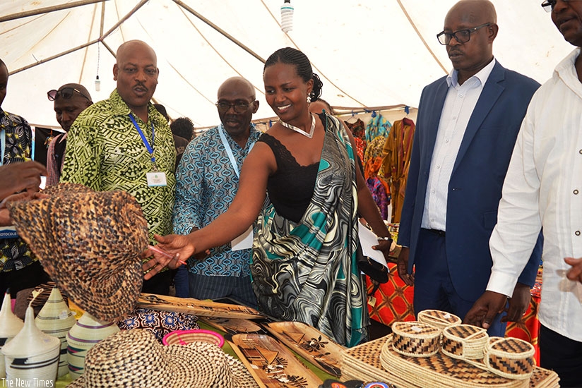 Muhongerwa (centre) and PSF officials tour the expo at car free zone. / Sam Ngendahimana.