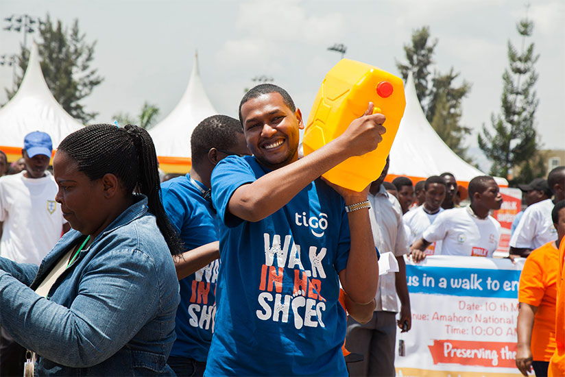 A man walks with a jerrycan of water during the 'Walk in Her Shoes' campaign in Kigali yesterday. / Nadege Imbabazi