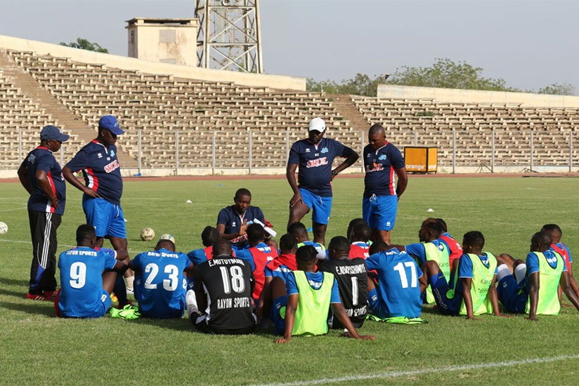 Rayon Sports head coach Masudi (circled) talks to his players after their first training session at Stade Modibo Keita in Bamako on Thursday afternoon. / Courtesy