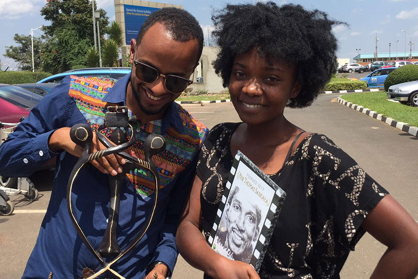 Dusabejambo with the Thomas Sankara prize while a friend admires the La Chance award plaque at Kigali International Airport shortly after her return from Burkina Faso.