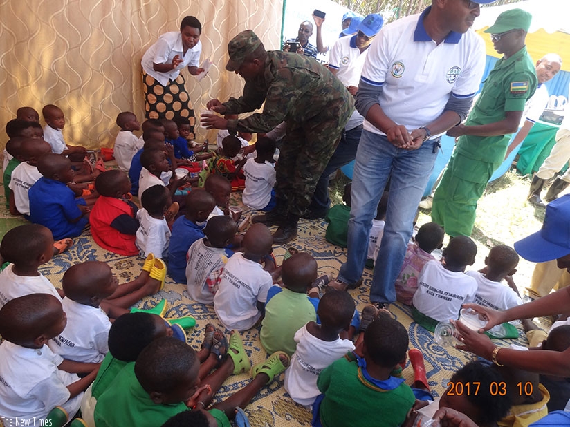 Officials hand over cows to poor households during the closure of Girinka Week in Gicumbi District on Friday. Michel Nkurunziza. 
