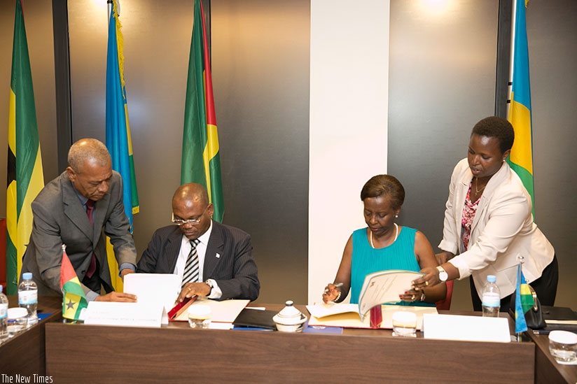 Mushikiwabo (R) and Botelho sign the agreements at the weekend. Courtesy.