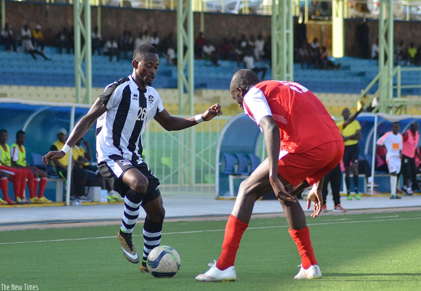 APR striker Issa Bigirimana tries to beat Kirehe defender Abdoul Nshimiyimana during first round clash. Both sides drew 0-0 in the league second round on Saturday. Sam Ngendahimana.