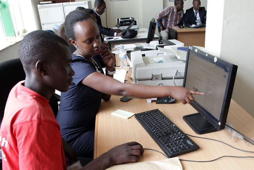 An RDB staffer guides a client on how to register business online. / File