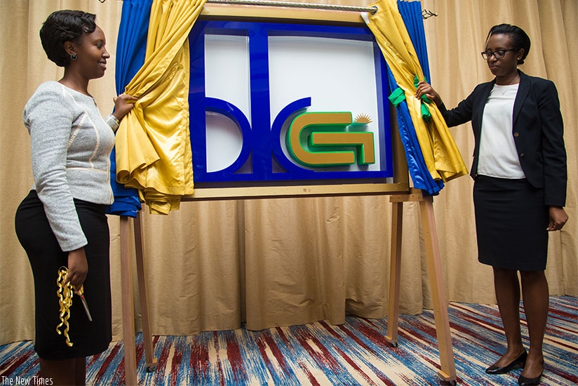 BK General Insurance Board Chairperson Sandra Rwamushaija (L) and Bank of Kigali CEO Dr Diane Karusisi unveiling the logo of the new insurance company yesterday. Faustin Niyigena
