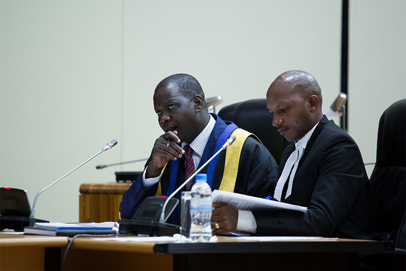 EALA Speaker Daniel Kidega (L) and Stephen Gasana, senior clerk assistant during a session last week. / Timothy Kisambira