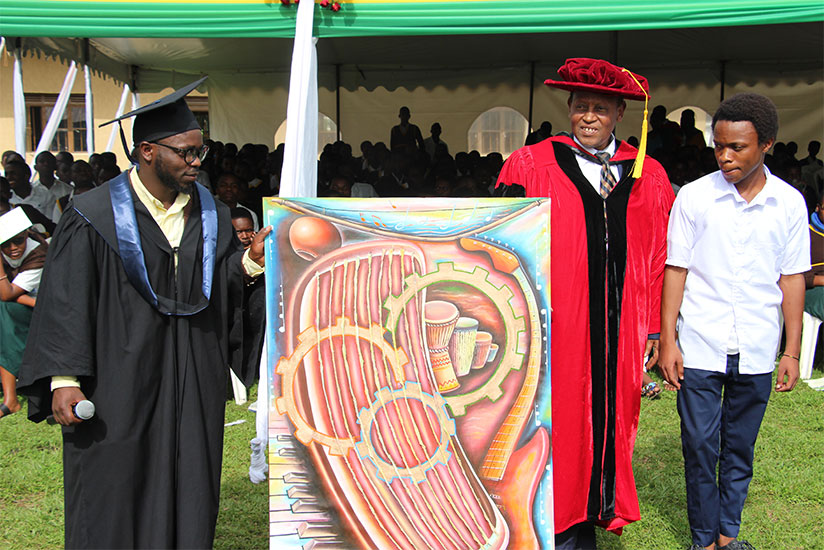 Dr Vuningoma receives a gift from the school. The art piece was drawn by one of the students in visual art (in school uniform)