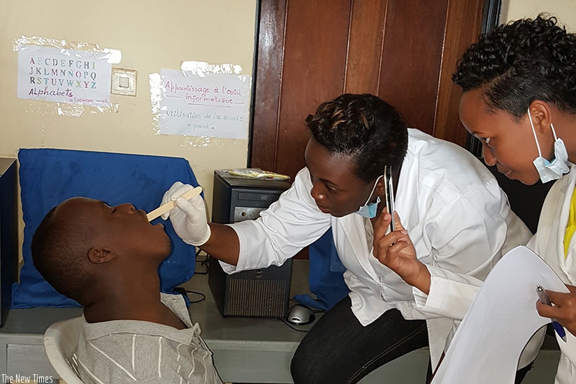 Dental surgeons examine one of the children with mental disabilities at Tubiteho Centre in Kigali. Hudson Kuteesa.
