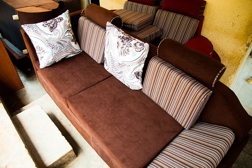 The young entrepreneur makes furniture like this one. Below, Ufitikirezi makes chair covers. / Timothy Kisambira.