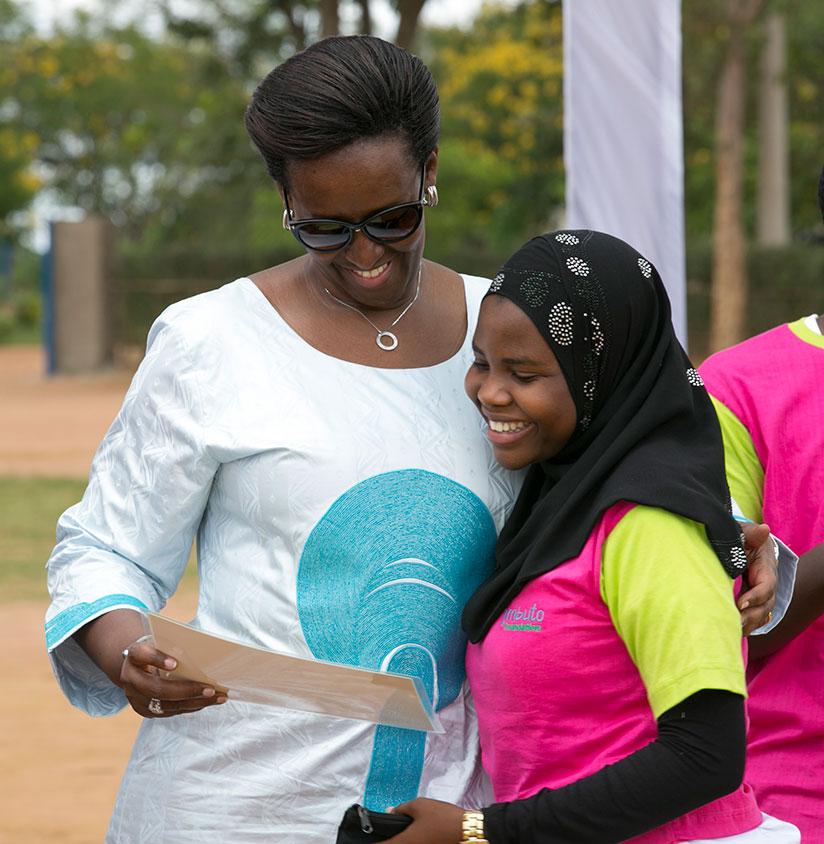 The First Lady, Mrs Jeannette Kagame, congratulates one of the best performing girls during the closing ceremony this year's Promotion of Girls Education Campaign in Mayange Sector....