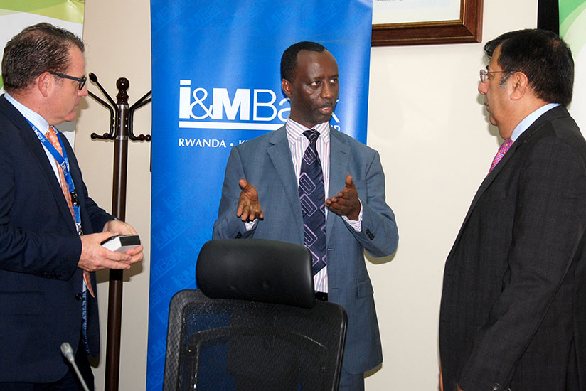 I&M Bank managing director Robin C. Bairstow (L), Development Bank of Rwanda (BRD) chief executive Alex Kanyankole (C)  and Banque Populaire du Rwanda managing director Sanjeev Ana....