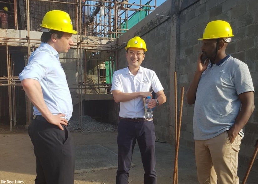Daniel Krebs (left) and Ferwafa president Vincent Nzamwita (right) hold talks with an official from CCECC company that is constructing Ferwafa hotel. Courtsey