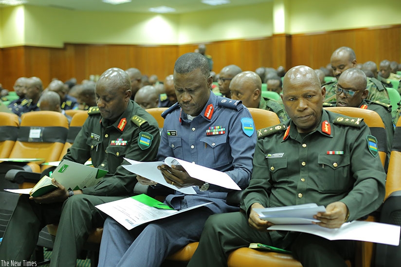 Senior RDF officers and members of Zigama-CSS read through the agenda during the meeting at RDF Headquarters in Kimihurura. File. 