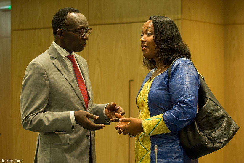 Chief Justice Sam Rugege (L) chats with the Minister for Gender and Family Promotion, Esperance Nyirasafari, after the opening of the meeting of judges and senior judiciary officia....