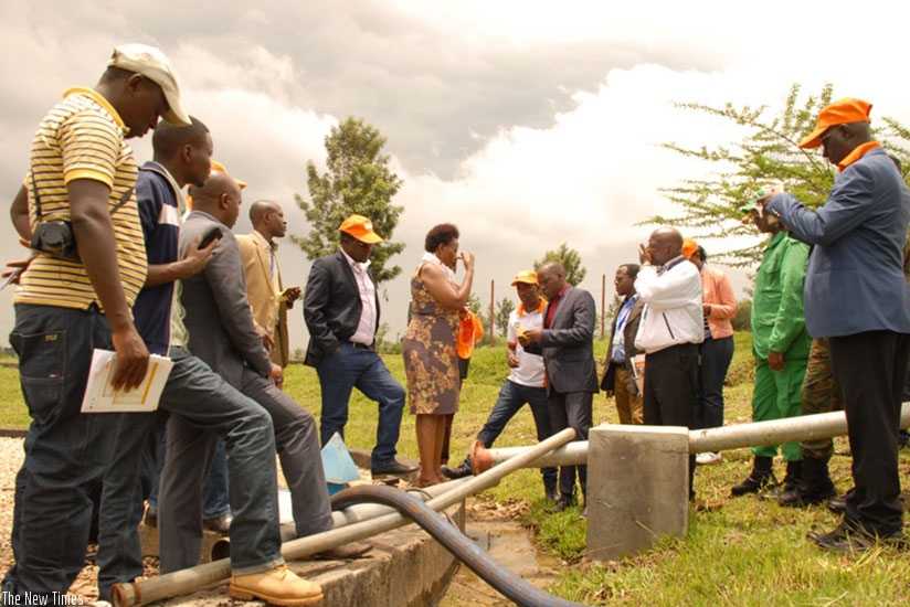 Officials visit the plant's water tank in Gatsibo District recently. (Kelly Rwamapera)