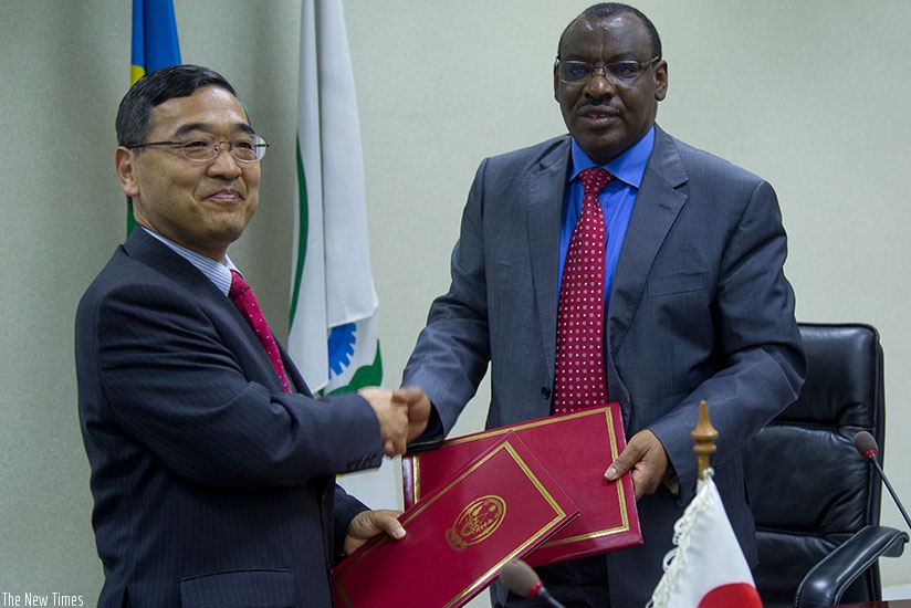 Amb. Miyashita (L) and Minister Gatete exchange documents yesterday. (Photos by Timothy KIsambira)